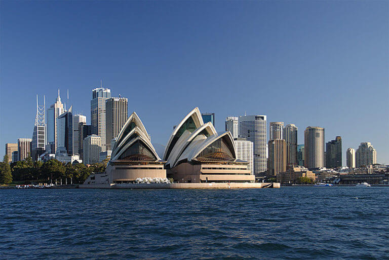 The Sydney Opera House viewed from the water with the city skyline behind (Australia)